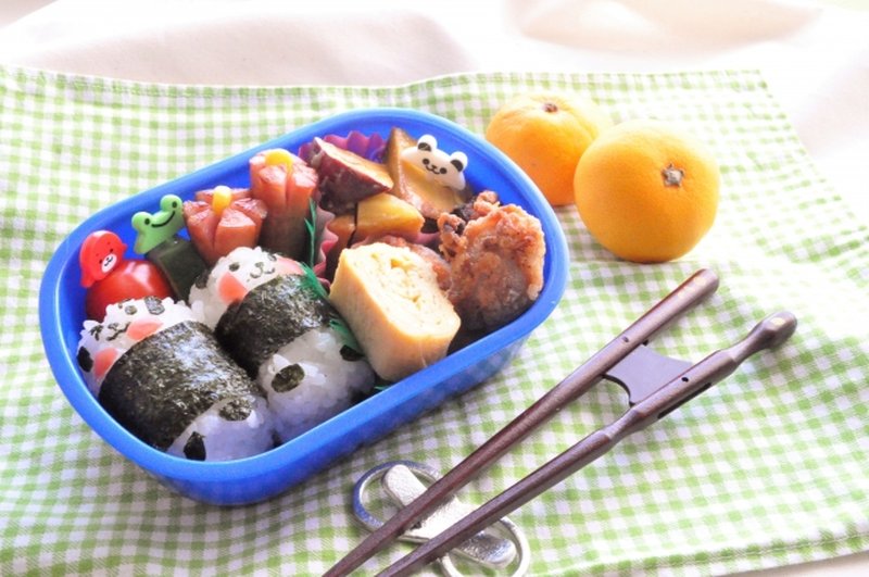Panda-shaped onigiri bento in a blue box — a design typical of what parents make for preschool excursion days in Japan